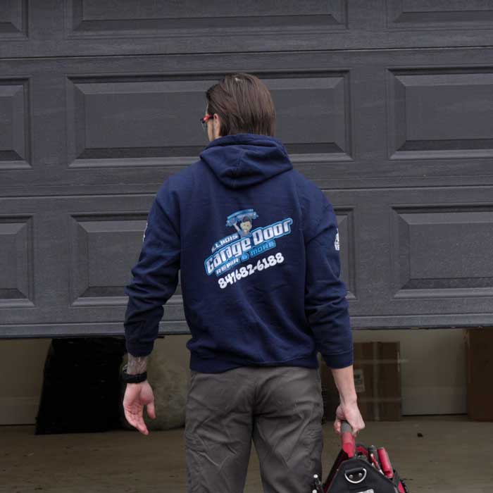 A local garage door technician opening the garage door near Northbrook IL